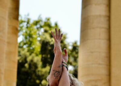 a woman with her arms raised in the air
